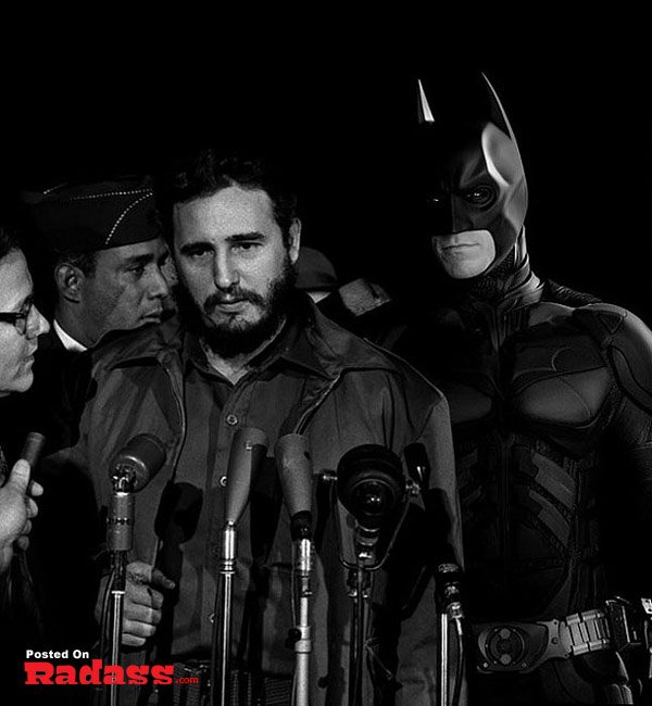 A man dressed as Batman poses in front of microphones, showcasing iconic superheroes throughout history.