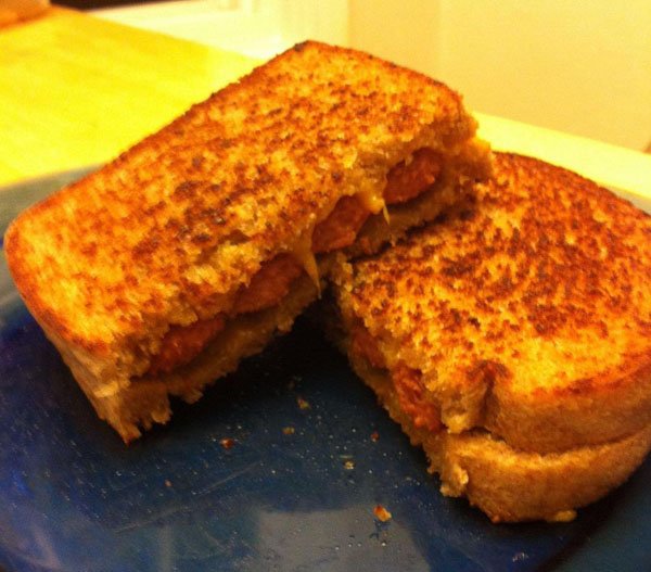 A grilled cheese sandwich on a blue plate is one of the 16 meals every college student needs to survive.