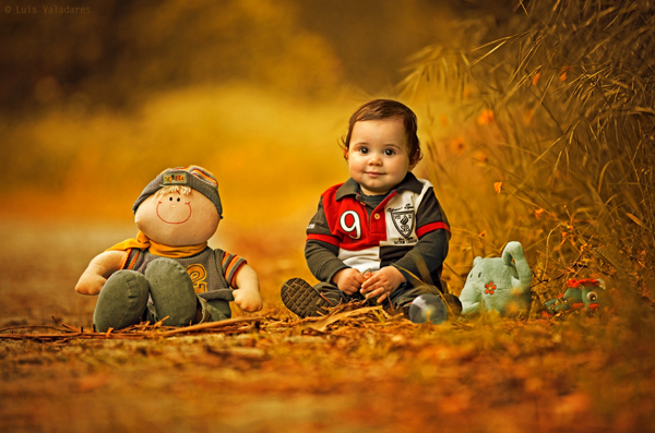 A cute baby sitting on the ground with a stuffed animal, providing plenty of cool pics to brighten your Saturday.