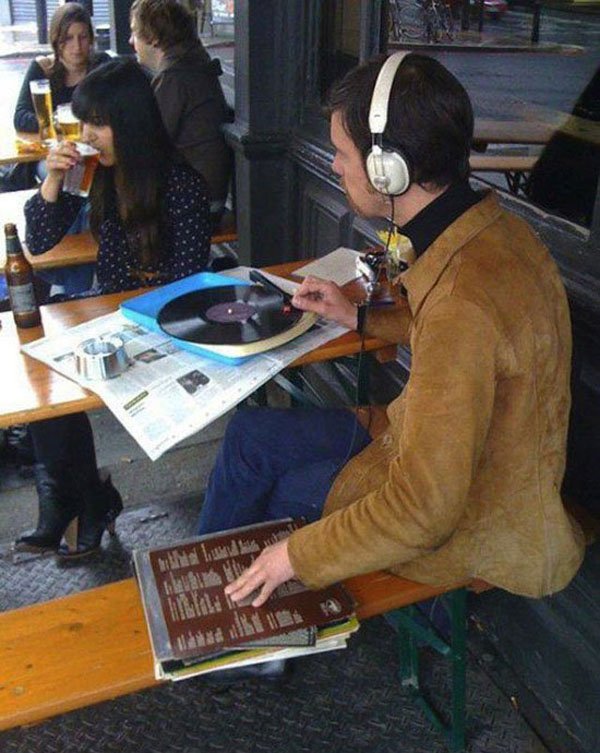 A hipster sitting on a bench.