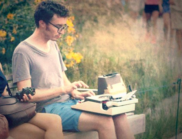 Two hipsters sitting on a bench.