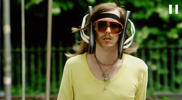 A man in a yellow shirt with sunglasses on his head, exuding an air of Hipsters Have Gone Too Far.