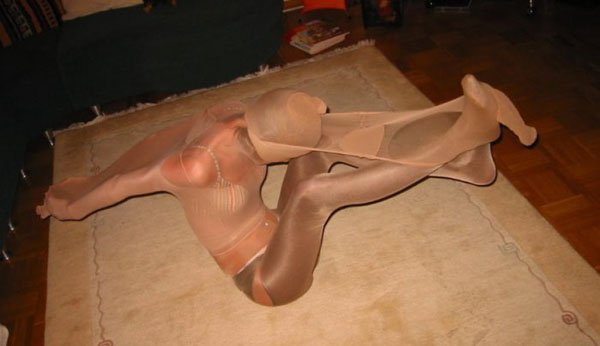 A woman is sitting on a rug with a pair of stockings on.