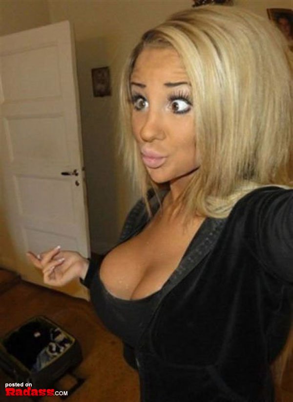 A woman with big tits is taking a picture that would make you say