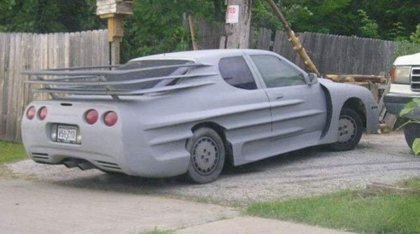 A WTF car parked next to a fence.