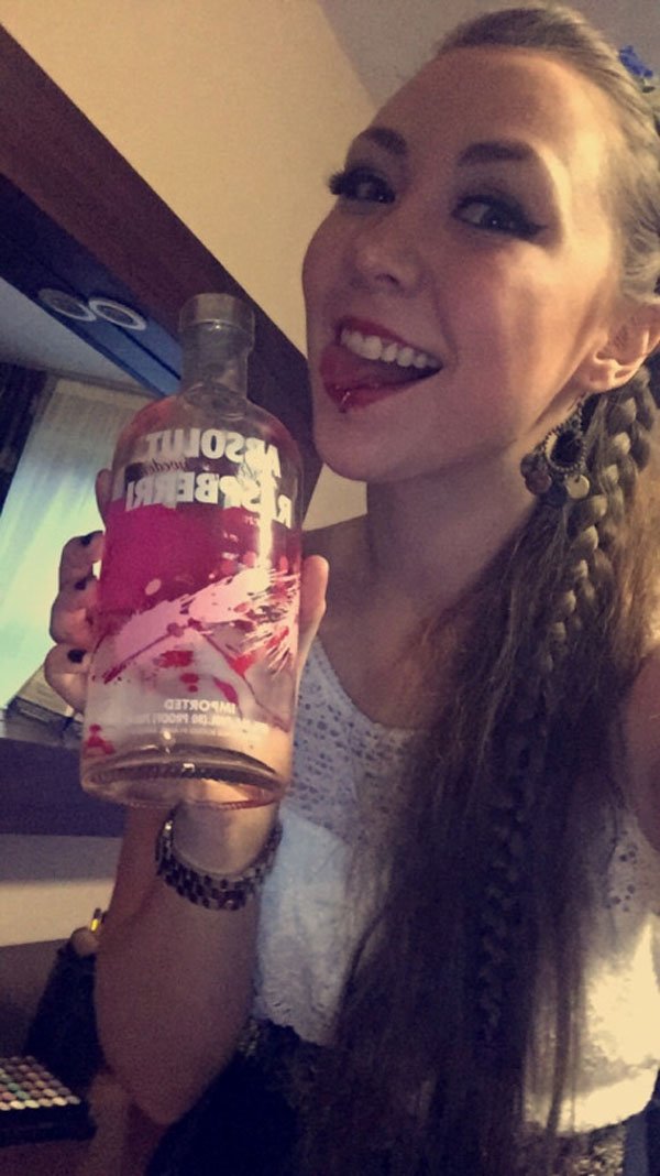 A woman confessing her weekend indulgence with a bottle of alcohol.