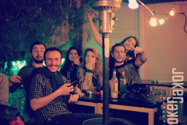 A group of people gathering around a table for Weekend Confessions.