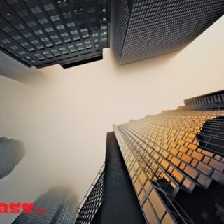 A beautiful photograph of a skyscraper captured on a foggy day.