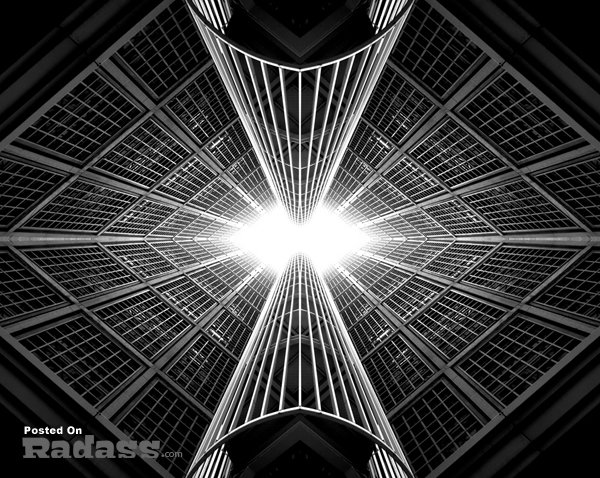 A stunning black and white photograph showcasing exquisite architecture with a luminous glow penetrating through it.