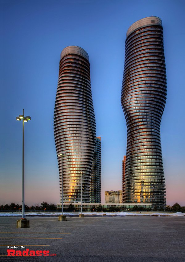 HQ photographs of two beautiful tall buildings in a parking lot.