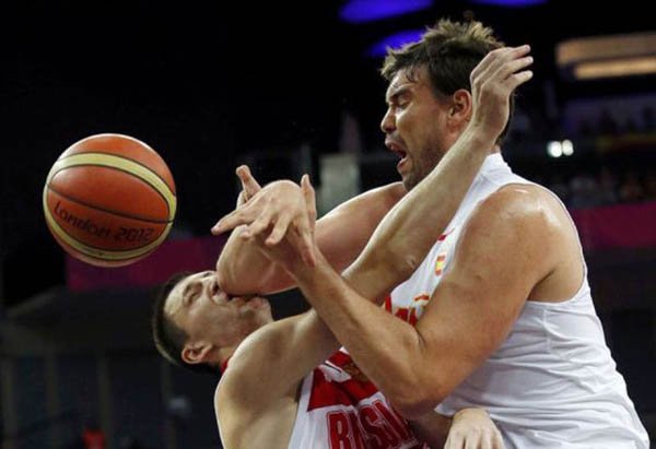 Two basketball players fighting for the ball in a game, resulting in an I Hate It When This Happens moment as one player face plants.