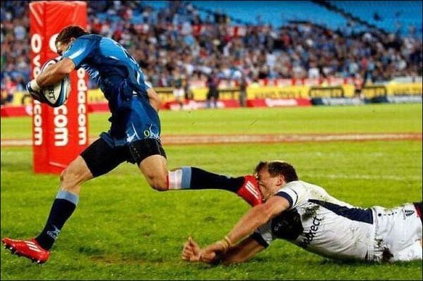 A rugby player attempts to score a try but unfortunately face plants during the game.