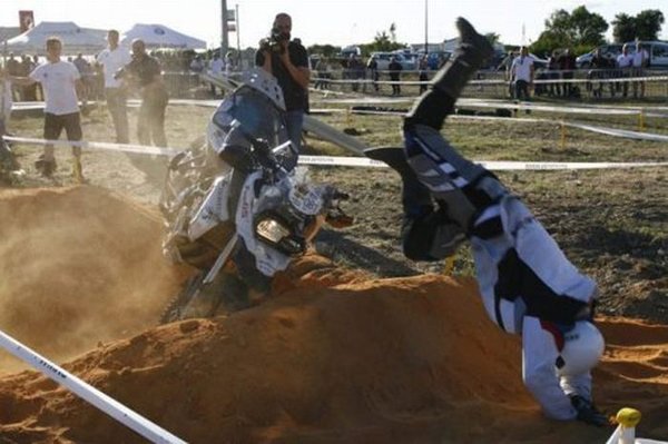 A man on a motorcycle face plants into a sand pit
