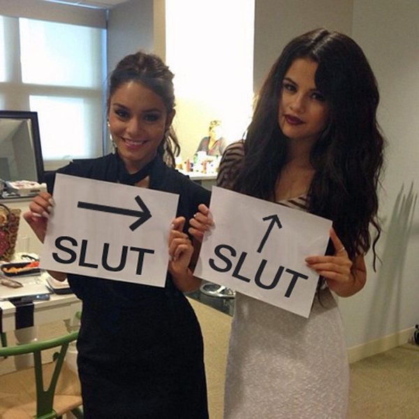 Selena Gomez graciously poses with signs that say