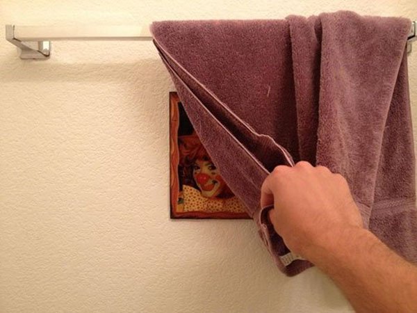 A purple towel hanging on a wall, defying the trolls.