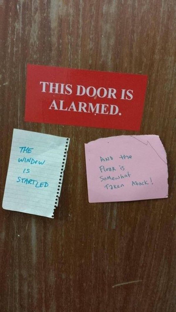 An alarmed door with a note warning against trolls.