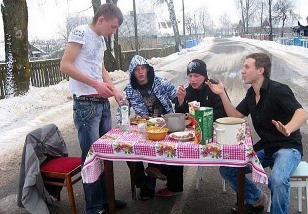 Two men observing a fish tank.