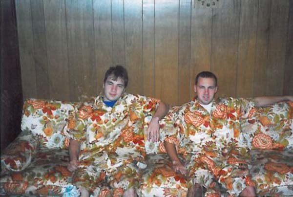 Two men observing a fish tank.