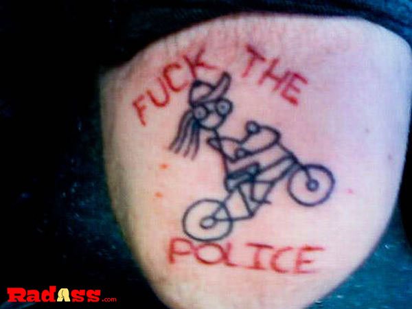 A provocative tattoo showcasing defiance towards authority, capturing the essence of living in the moment.