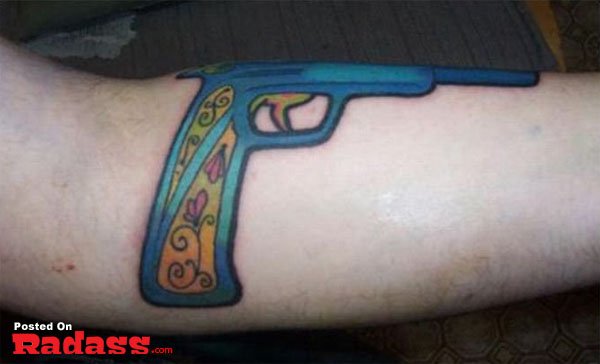 A tattoo depicting a gun on an arm, symbolizing 32 individuals carrying for life.
