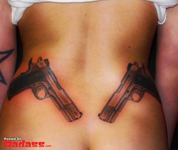 A woman sporting two guns tattooed on her back from