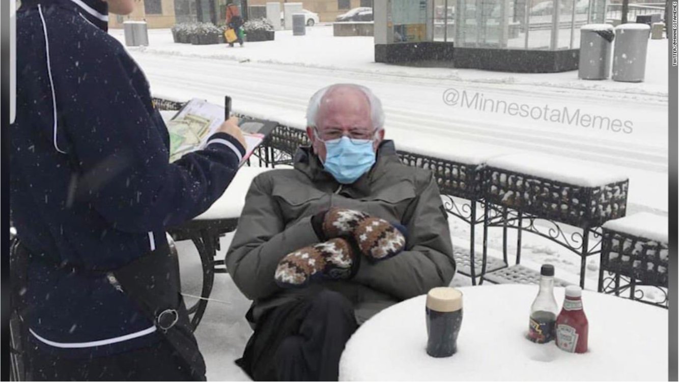 A man wearing a face mask sitting at a table in the snow goes viral as one of the top Bernie Sanders Inauguration Memes.