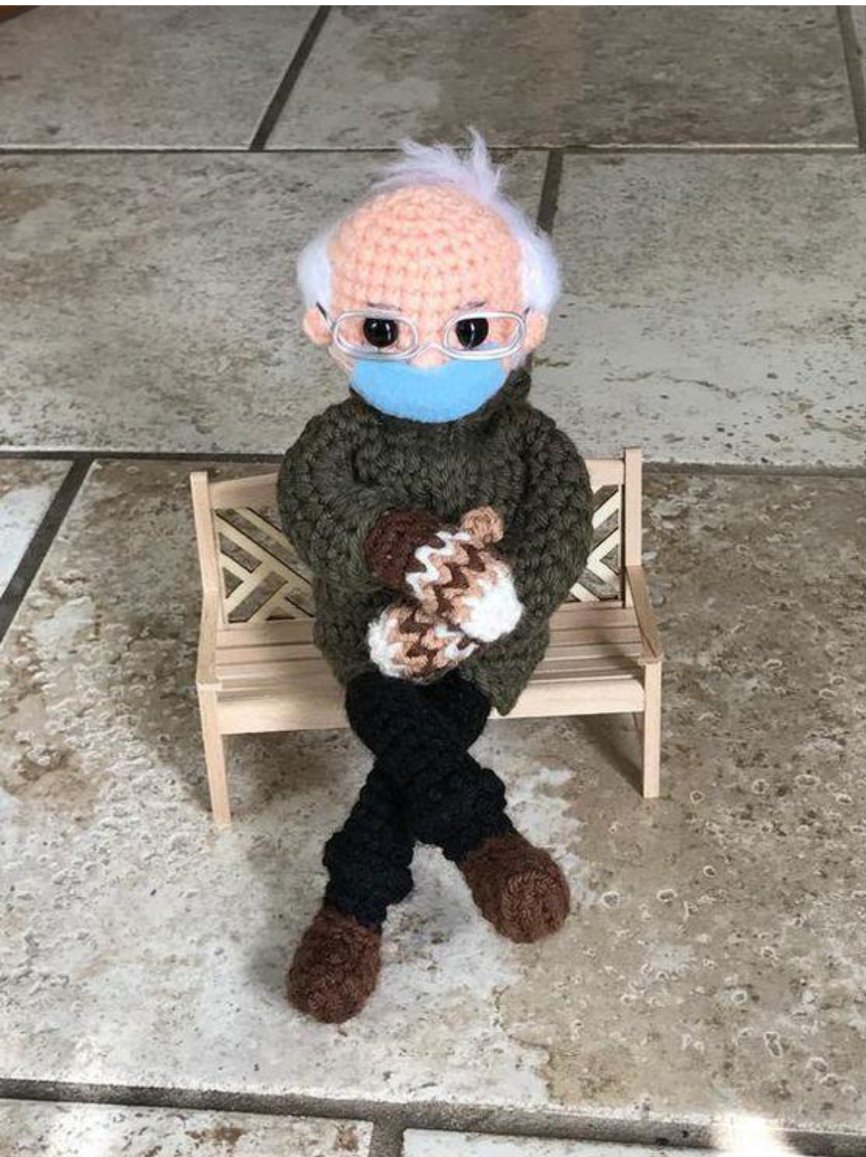 A crocheted Bernie Sanders doll on a bench at the inauguration.