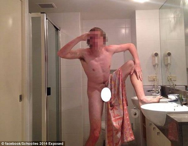A naked man in a bathroom.