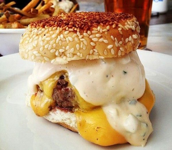 A mouthwatering burger with cheesy goodness and a side of crispy fries, perfect for satisfying those hunger pangs or indulging in some food porn.