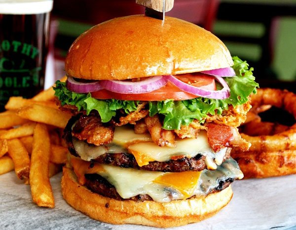 A scrumptious burger paired with crispy fries and a delightfully refreshing beer—food porn at its finest.