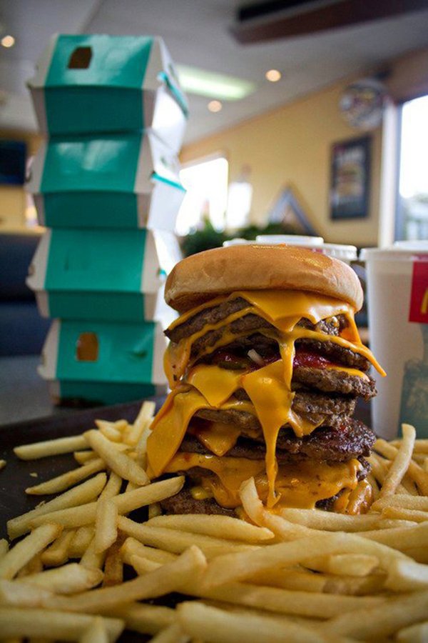 A mouthwatering McDonald's burger and French fries on a plate.