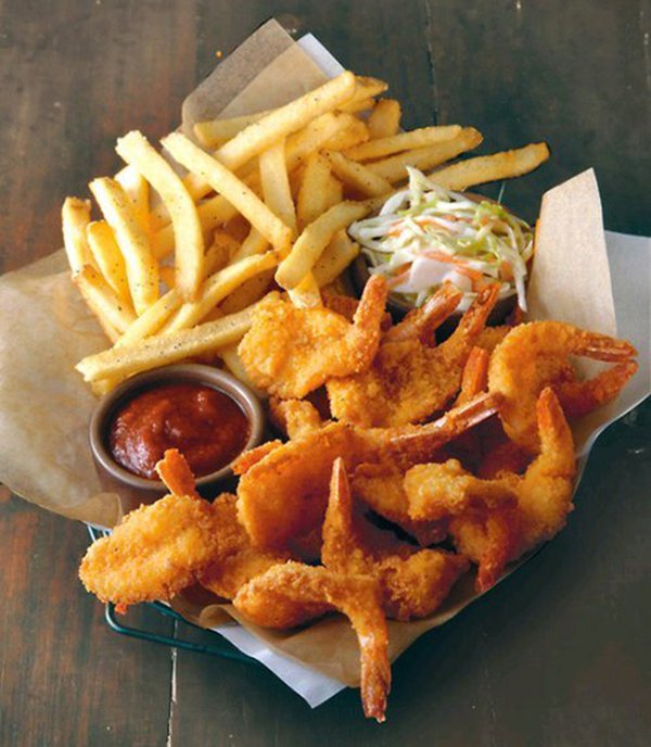 Hungry? Get some food porn with fried shrimp, french fries, and ketchup in a basket.