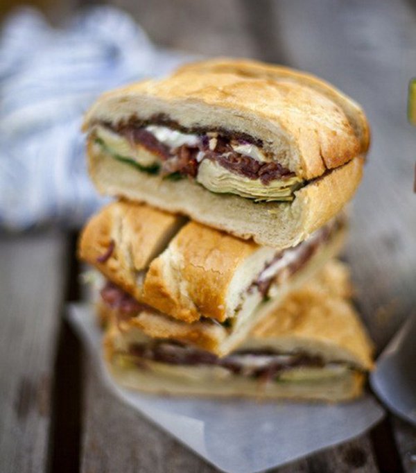 Hungry? Stack of sandwiches on a wooden table.
