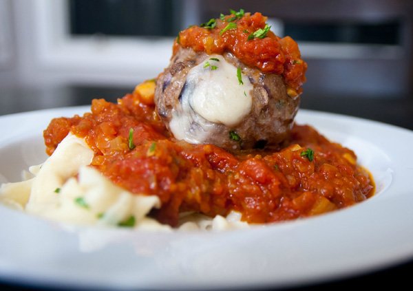 A tantalizing plate with delectable meatballs drenched in savory sauce, perfect for food porn enthusiasts.