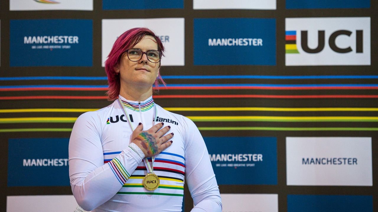 A medal-winning cyclist in a cycling uniform challenges perceptions of fairness for transgenders in the Olympics.