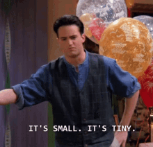 A man is pointing at balloons with the text