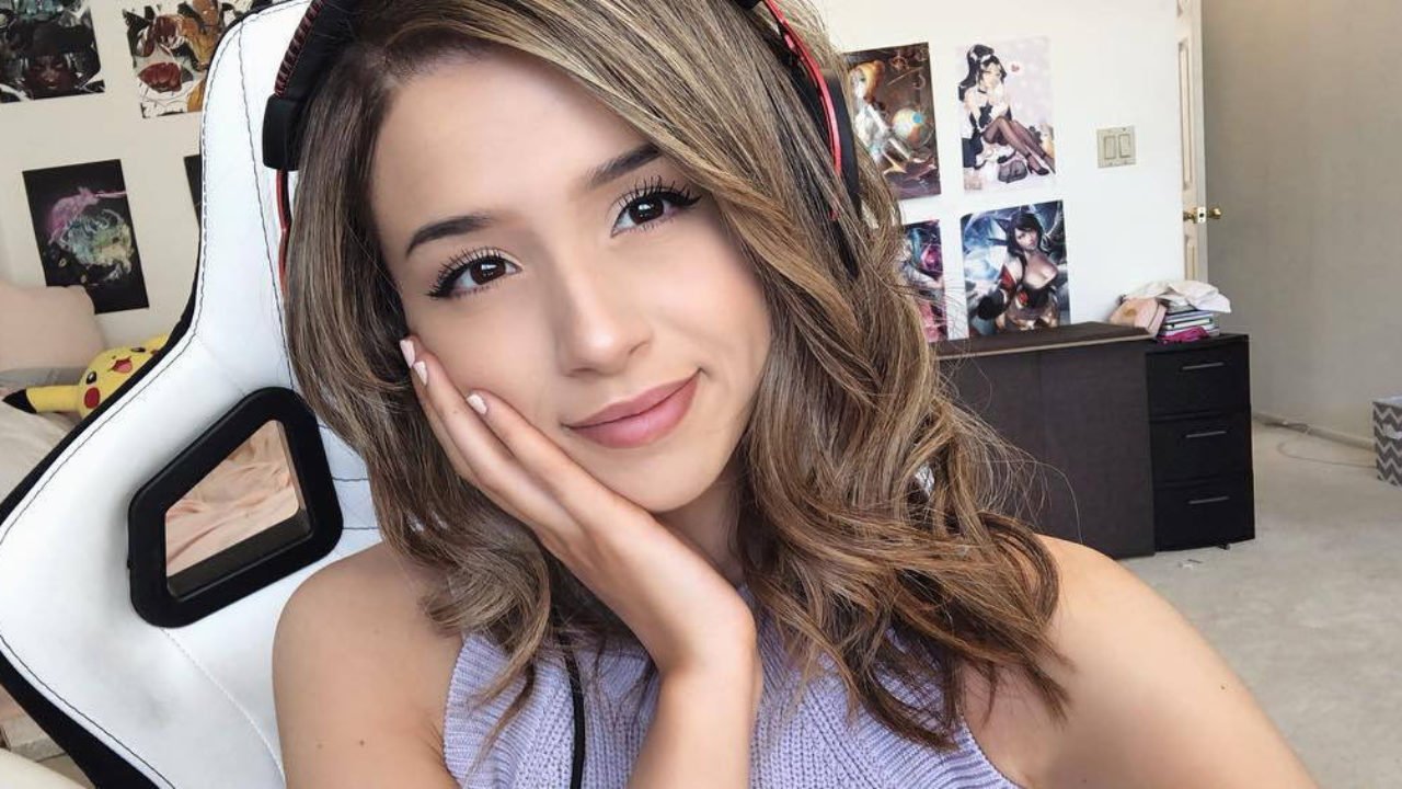 A girl wearing headphones is posing for a picture.