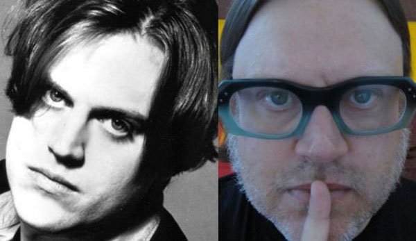 A black and white photo of a man with glasses and a man with a finger in his mouth, showcasing the appearance of pop stars from the 90's.