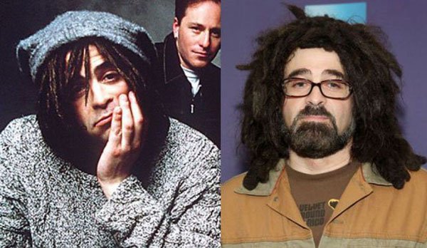 A man with dreadlocks and glasses next to a man with dreadlocks.