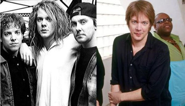 A black and white photo of a man posing with a band, showcasing Pop Stars of the 90’s.