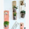 suspension-végétale-déco-murale-bois-citation-personnalisé-artisanal Décorations murales avec plantes en pots suspendus.