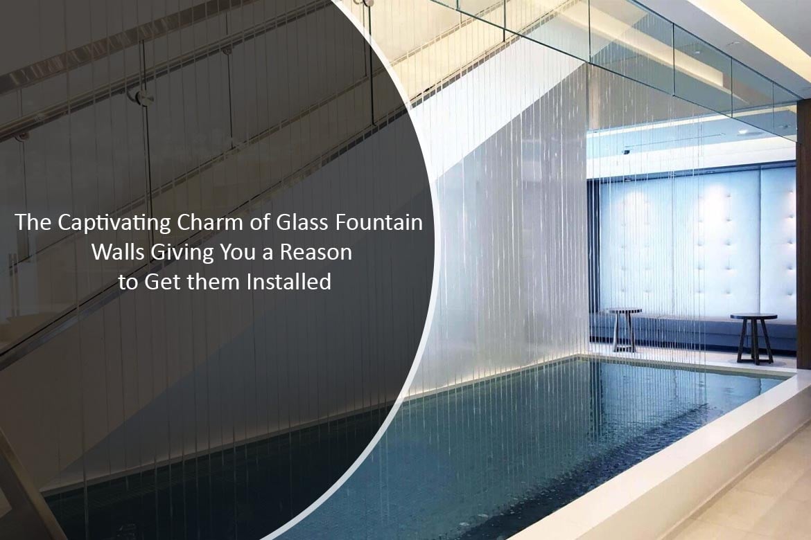 Indoor glass fountain wall with cascading water, enhancing elegance and tranquility in commercial spaces, reflecting the charm of water features by Midwest Tropical.