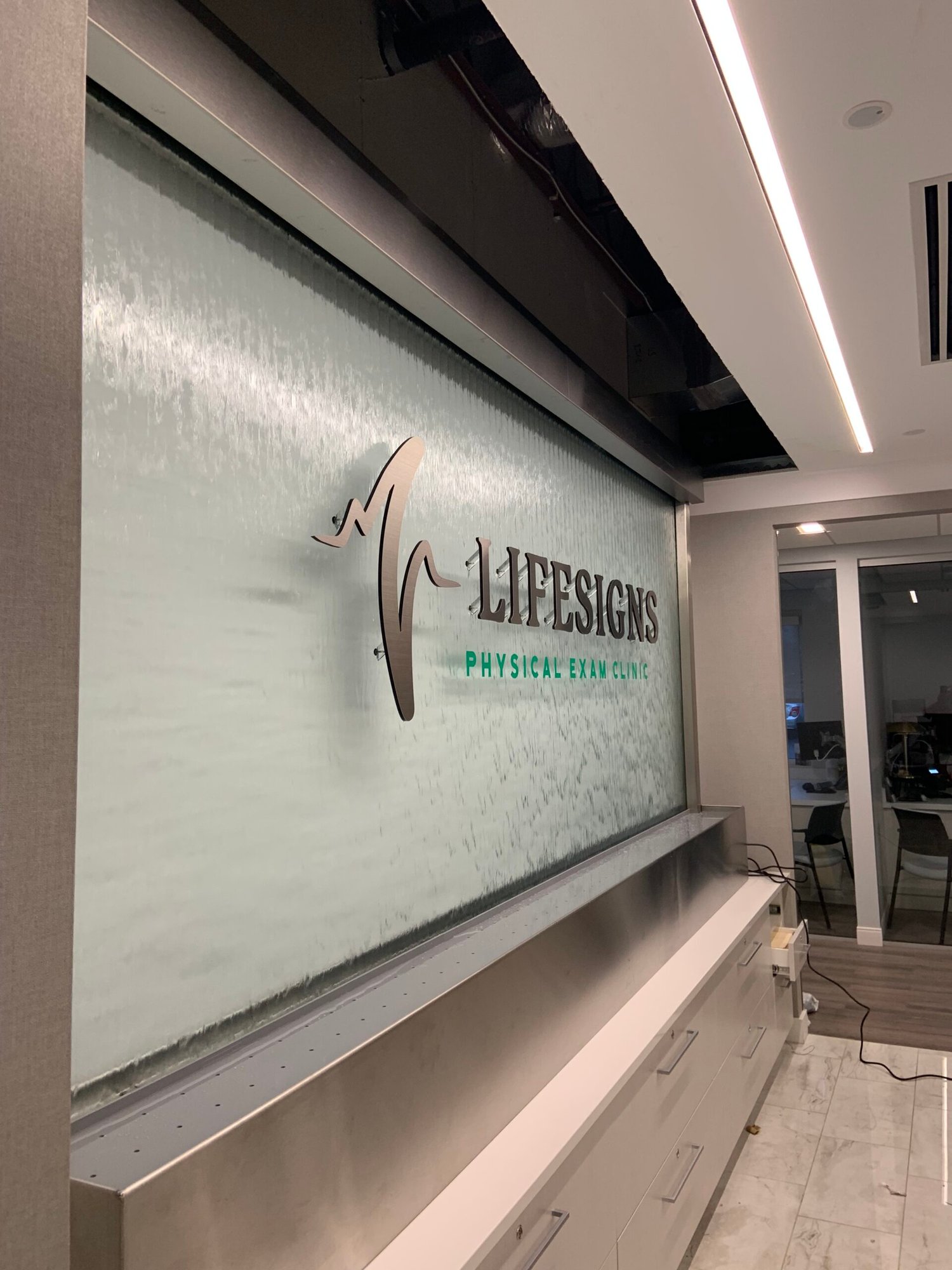 Glass Water Features 39 Glass Water Wall with Stainless Steel Frame and Off Mounted Logo for Lifesigns in Memphis TN 2 scaled