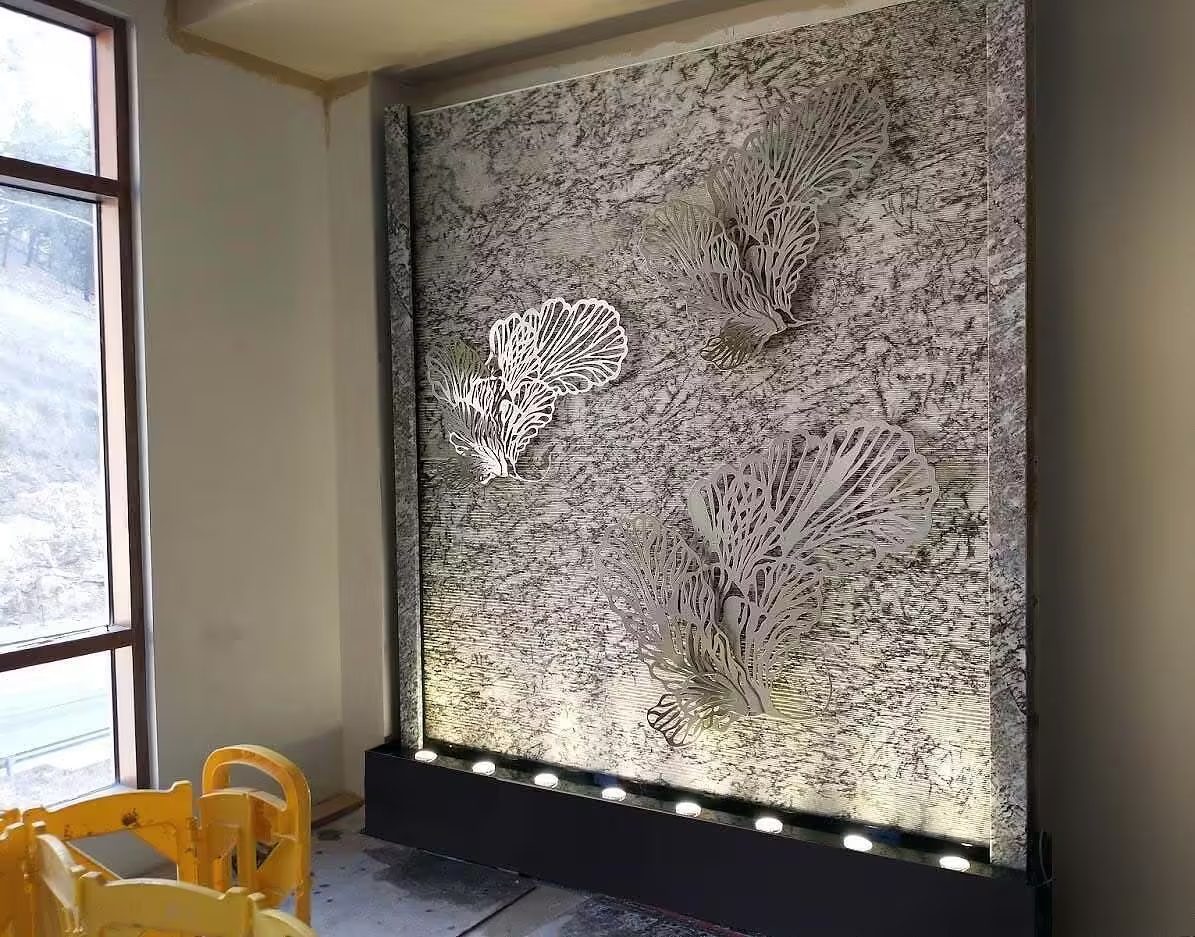 Custom bubble wall water feature with intricate designs, illuminated base, and modern aesthetic, enhancing indoor ambiance for commercial spaces.