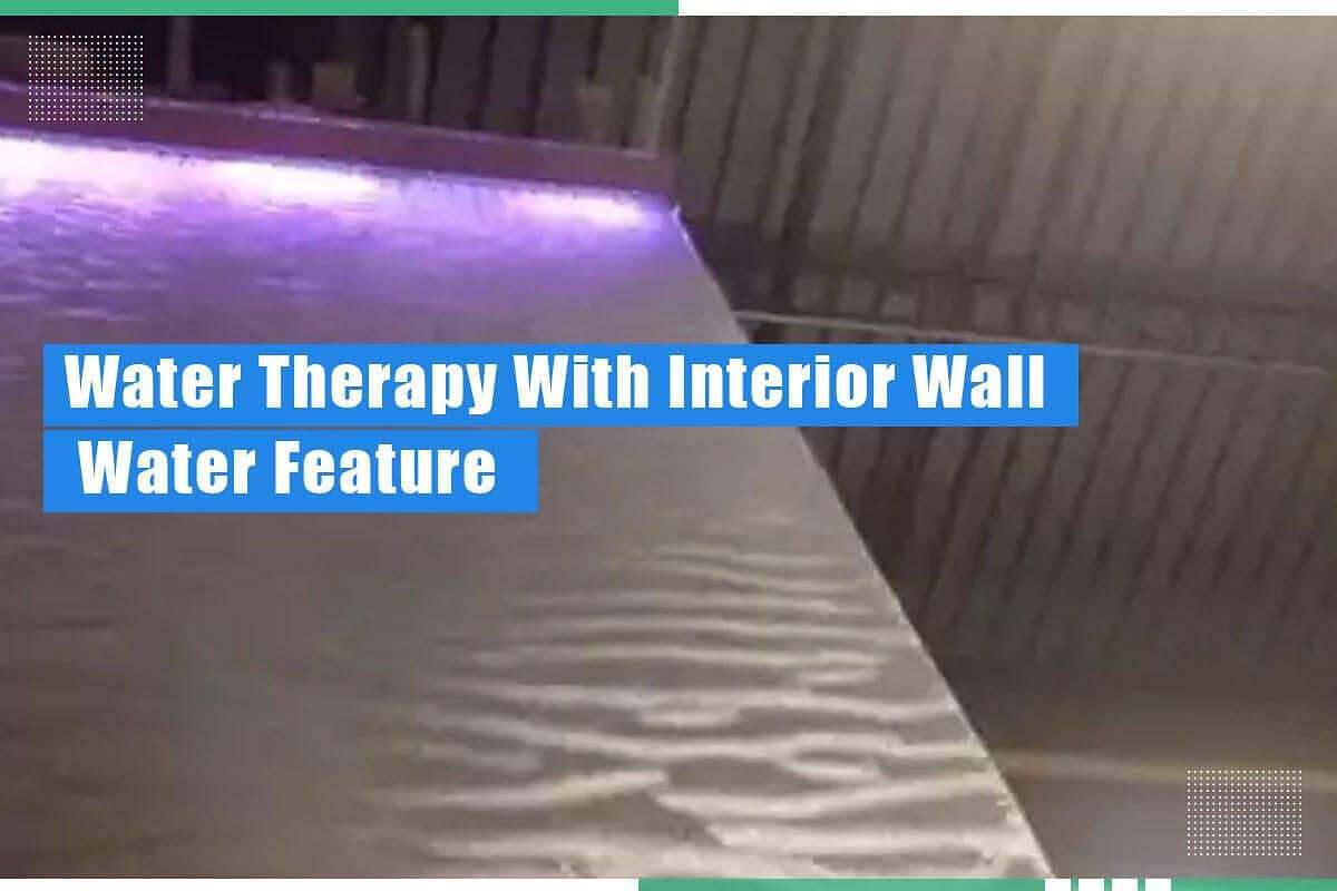 Interior wall water feature with flowing water and ambient lighting, illustrating water therapy benefits in home environments.