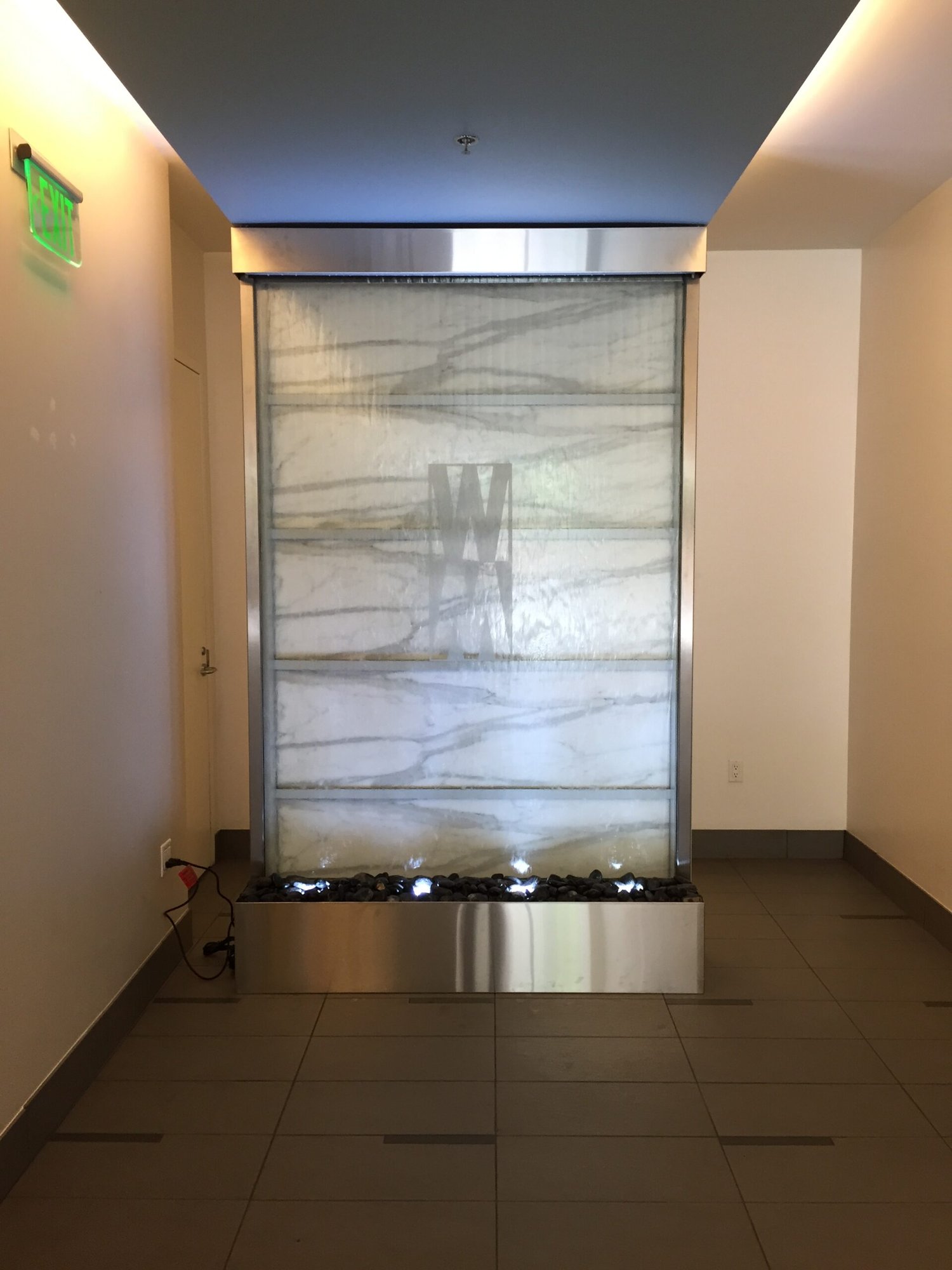 Glass Water Features 46 Glass and Stainless Water Wall with Marble Tile Behind at Watermark Tower in San Francisco California scaled