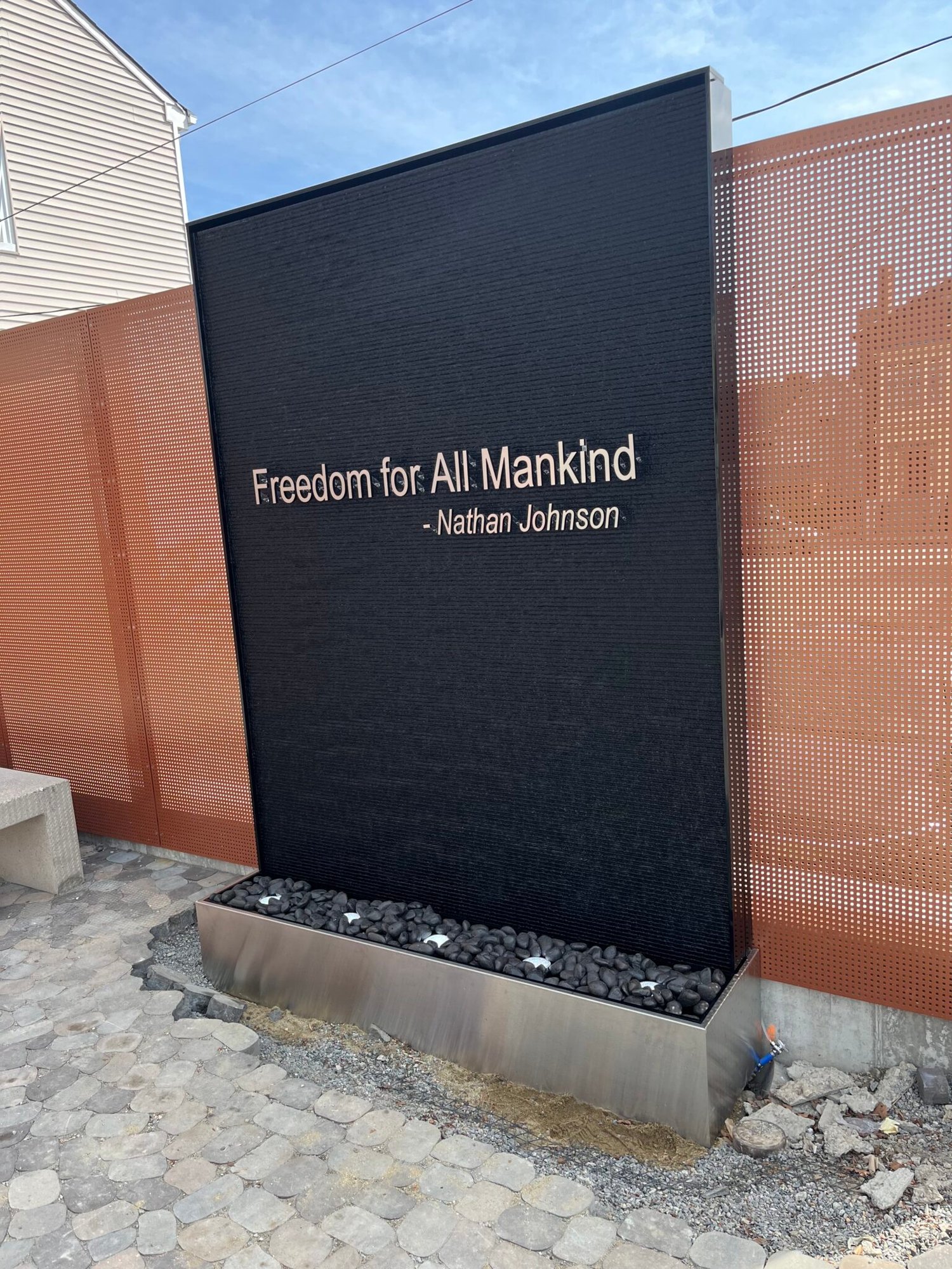 Outdoor Black Scored Acrylic Water Wall with Logo for Abolition Row Park in New Bedord, Massachusetts Outdoor Black Scored Acrylic Water Wall with Logo for Abolition Row Park in New Bedord, Massachusetts
