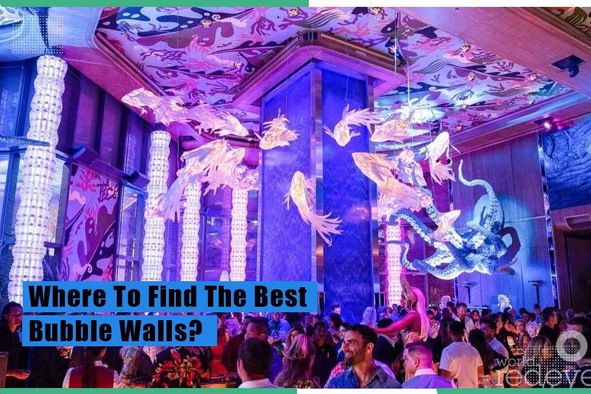 Colorful indoor setting featuring bubble walls, illuminated aquatic decorations, and a vibrant crowd, highlighting the allure of bubble walls in modern interior design.