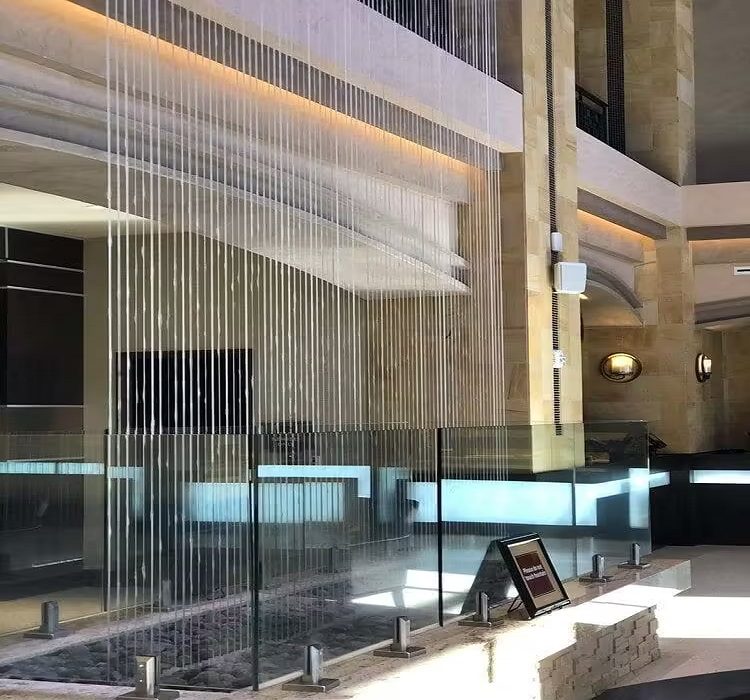 Interior rain curtain water feature in a modern architectural space, enhancing aesthetic appeal and promoting wellness.