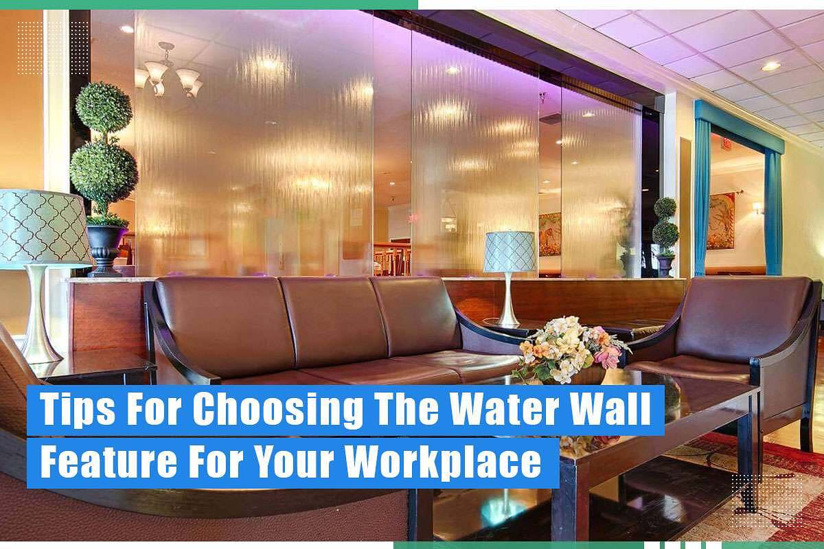 Interior view of a modern workplace featuring a decorative water wall, brown leather seating, a stylish lamp, and potted greenery, illustrating tips for choosing a water wall feature for enhancing workplace aesthetics.